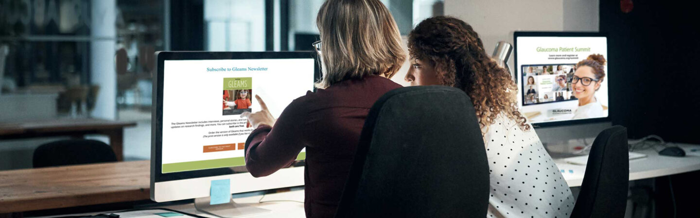 two women looking at a computer