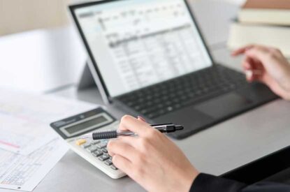 Close-Up Photo Of Preparing Financial Reports With A Computer And Calculator