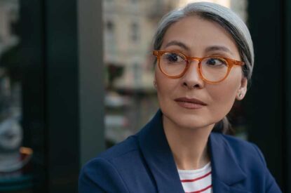 Thoughtful Middle-Aged Woman Wearing Glasses