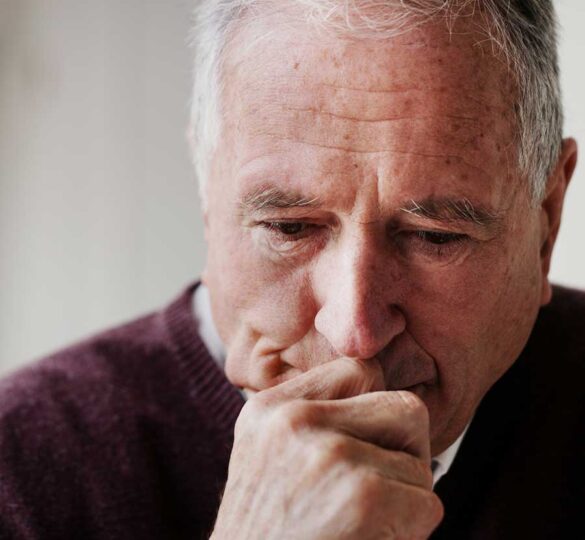 Close-up photo of older man feeling stressed or anxious