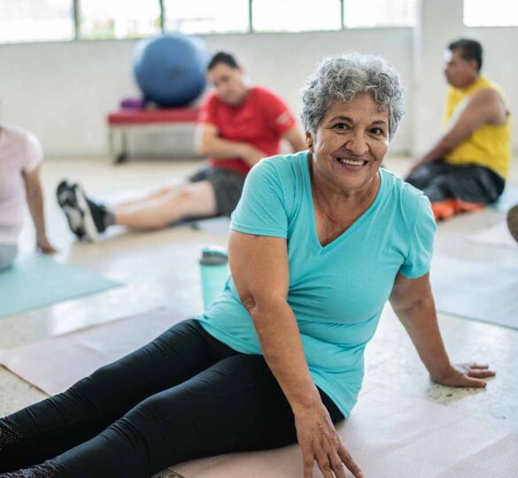 Older woman stretching in yoga class