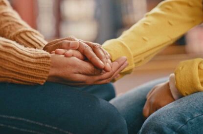 close-up photo of two people holding hands